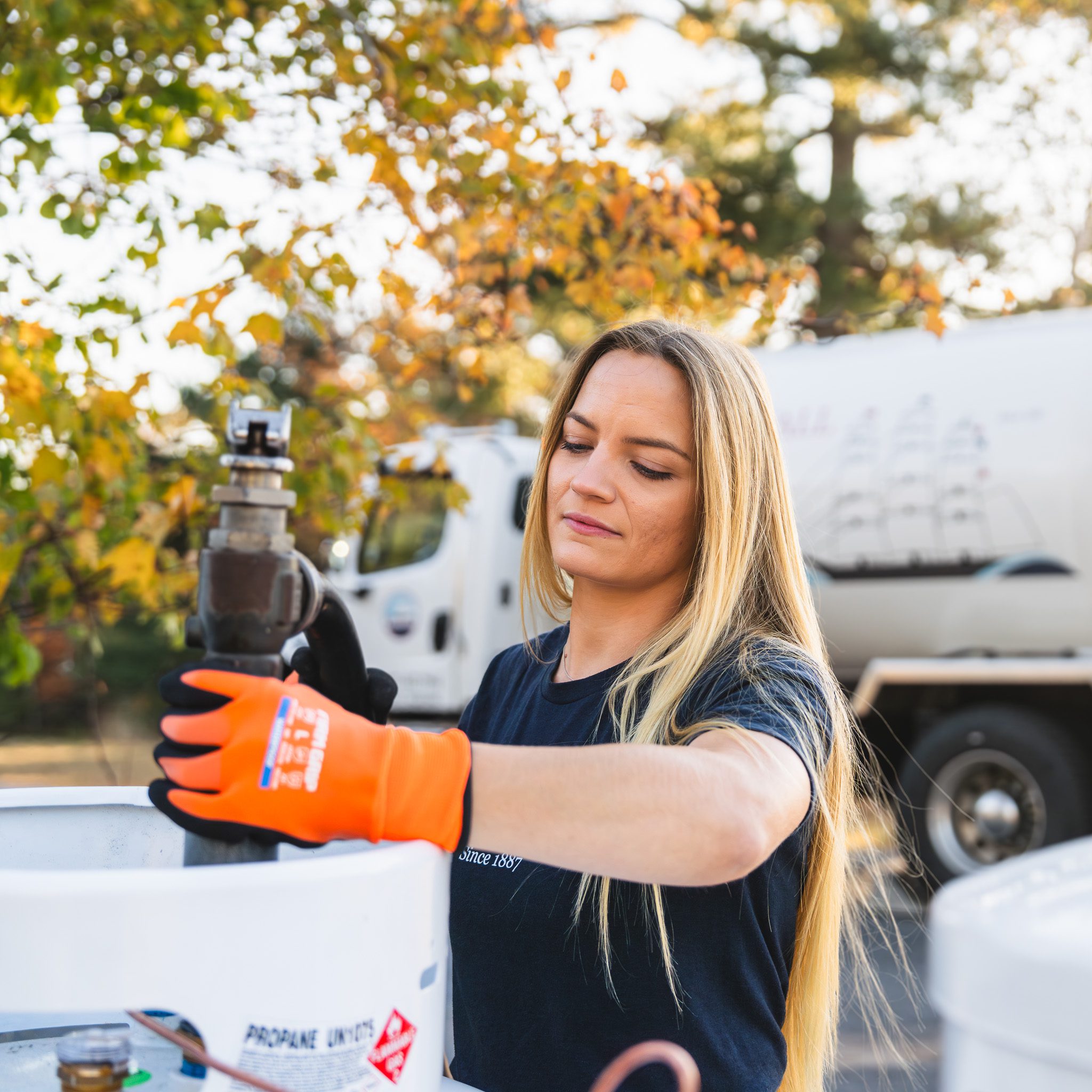Professional, local service you can count on in West Bath. M.W. Sewall driver Tierra filling a residential propane tank during a service call in West Bath, Maine.