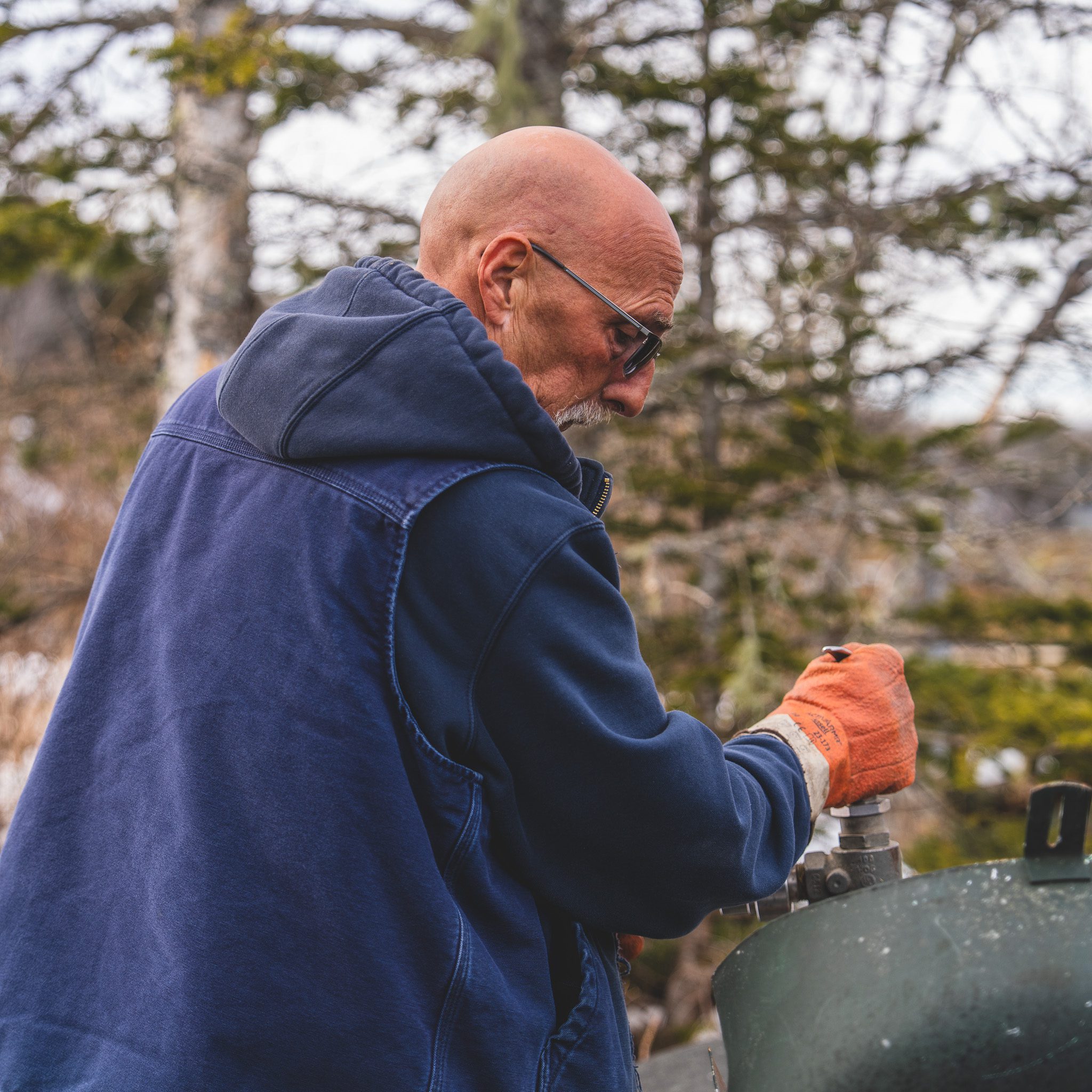 Professional, local service you can count on in Brunswick, Maine M.W. Sewall driver Tierra filling a residential propane tank during a service call in Brunswick, Maine.