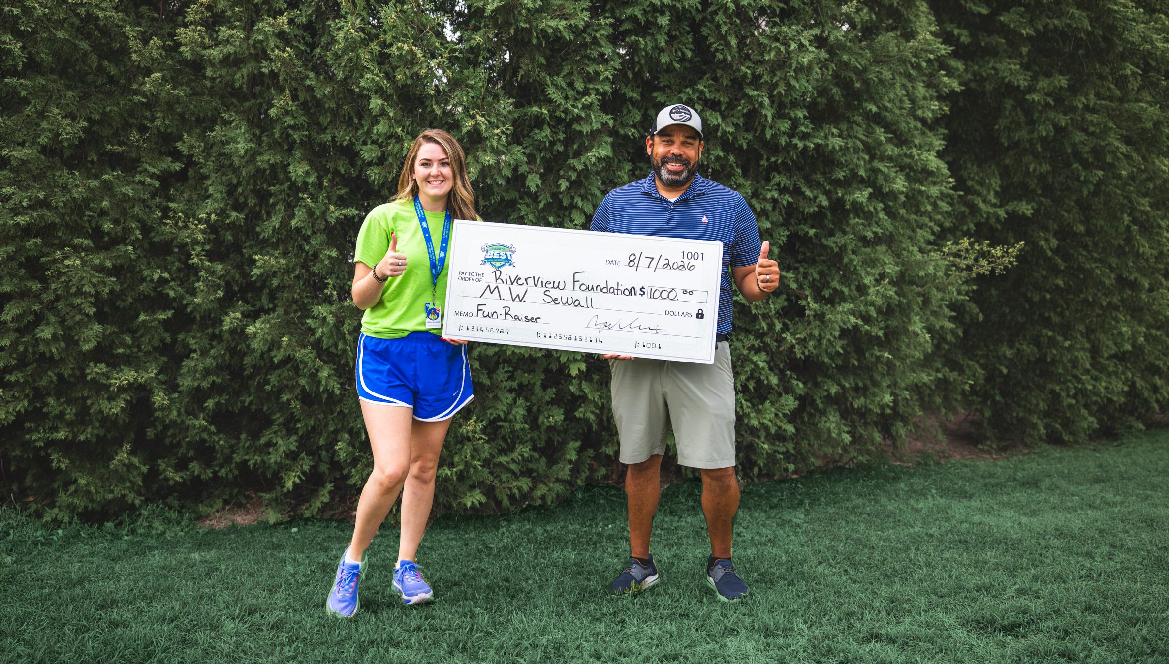 riverview-foundation-sponsor M.W. Sewall employee presenting a sponsorship donation check to a Riverview Foundation representative in Maine